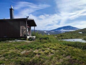 Hütte vor Bergen und blauen Himmel